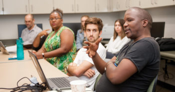 eSwatini Ministry of Health official Nqaba Nhlebela (right) talks with U of R spatial studies students and faculty members during a Mapping Monday session. (Photo by Coco McKown '04, '10)